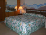 King size bed in a hotel room at Waikiki Beach